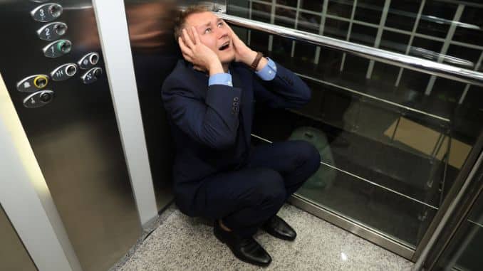 businessman having panic attack elevator